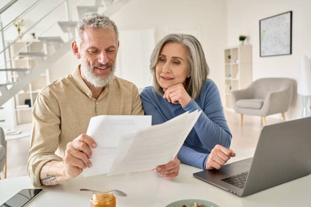 Couple reviewing their surplus funds documents together at home
